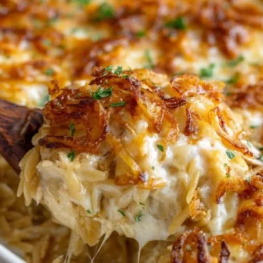 French Onion Chicken Orzo Casserole topped with melted cheese