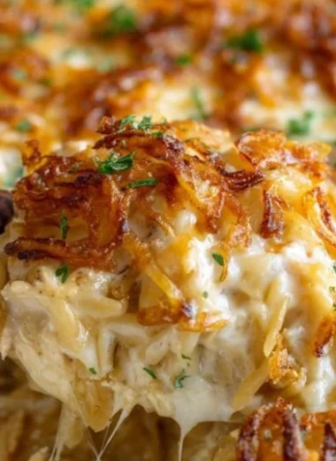 French Onion Chicken Orzo Casserole topped with melted cheese
