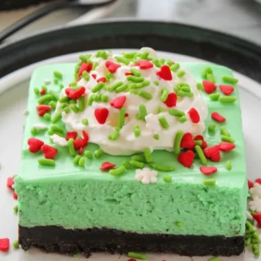 No Bake Grinch Christmas Cheesecake decorated for the holiday season