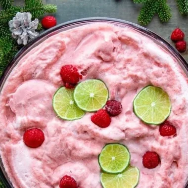 Sherbet Christmas Punch 3 A festive bowl of Sherbet Christmas Punch with colorful fruits and decorations