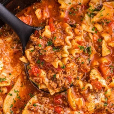 Bowl of Slow Cooker Lasagna Soup topped with cheese and basil