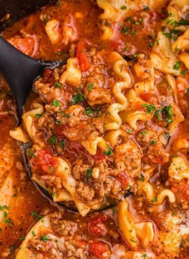 Bowl of Slow Cooker Lasagna Soup topped with cheese and basil