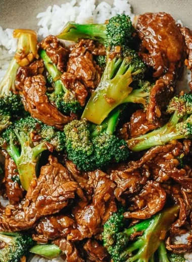 A plate of Chinese Beef and Broccoli with vibrant green broccoli and tender beef slices.