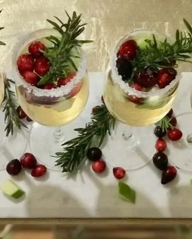 Festive Christmas Sangria in a glass with fruits and spices for holiday celebrations