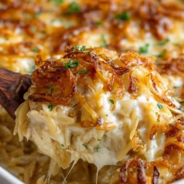 French Onion Chicken Orzo Casserole 2 French Onion Chicken Orzo Casserole topped with melted cheese and crispy onions.