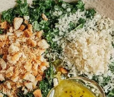 Fresh Lemon Parm Kale Salad topped with parmesan cheese and lemon dressing