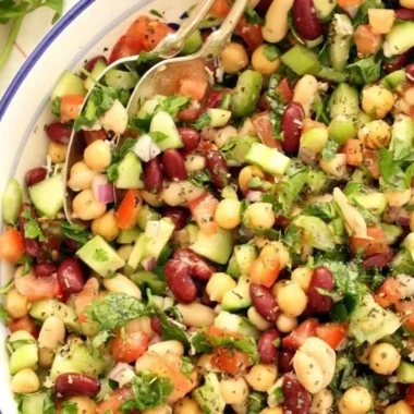 Colorful Mediterranean bean salad with fresh vegetables and herbs