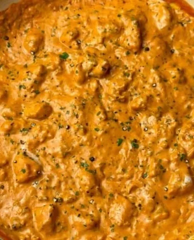 Delicious homemade butter chicken served with rice and garnished with coriander