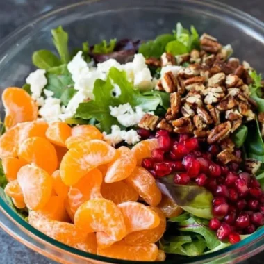 A vibrant winter salad with greens, nuts, and seasonal vegetables.