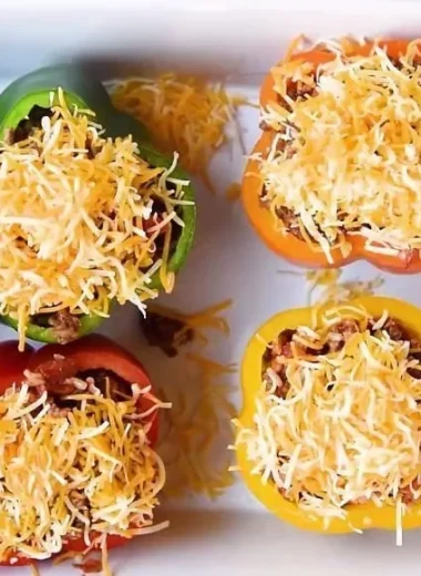 Colorful stuffed bell peppers with rice, meat, and vegetables on a plate