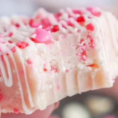 Valentine's Day Sugar Cookie Fudge Recipe 2 Valentine's Day sugar cookie fudge dessert in heart-shaped container.