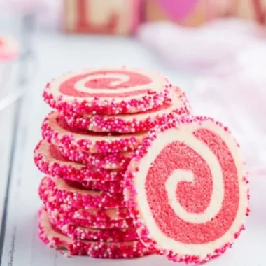 Valentine's Day swirl cookies with red and pink marbled designs on a white plate.