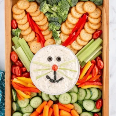 Colorful Easter veggie tray with fresh vegetables and dip for holiday gatherings