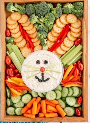 Colorful Easter veggie tray with fresh vegetables and dip for holiday gatherings